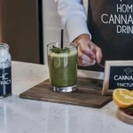 Person preparing a cannabis smoothie with THC extract and fresh herbs in a modern kitchen