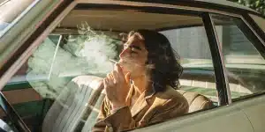Man Smoking Cannabis in a Vintage Car