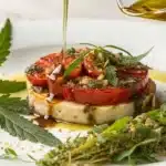 Close-up of cannabis oil being poured over a fresh dish, illustrating its use in gourmet cooking.