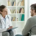 Doctor and patient discussing cannabis treatment for schizophrenia in a modern, serene clinical setting.