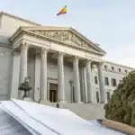 Realistic image of a Spanish government building with legal documents, symbolizing Spain cannabis laws and regulatory oversight.