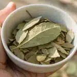 Realistic close-up of dried sugar leaves prepared for smoking, highlighting their texture and quality.
