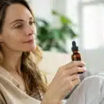 Woman holding THC tincture showcasing thc benefits for women