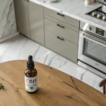 CBD oil bottle placed on a wooden table with a modern kitchen in the background.