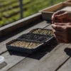 botanist sorting cannabis seeds by color and size on a wooden table