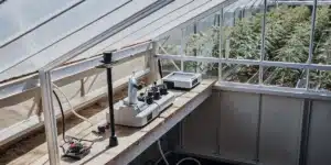 Laboratory equipment set up inside a greenhouse for cannabis quality control and plant analysis.