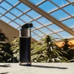 Portable digital refractometer displayed in an indoor cannabis grow room for precise brix and plant health monitoring.