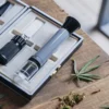 Cannabis refractometer kit displayed on a wooden table with cannabis leaves and buds