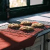 Cannabis cookies cooling on a wire rack by a sunlit kitchen window