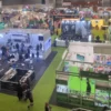 Large cannabis expo hall with multiple booths and attendees.