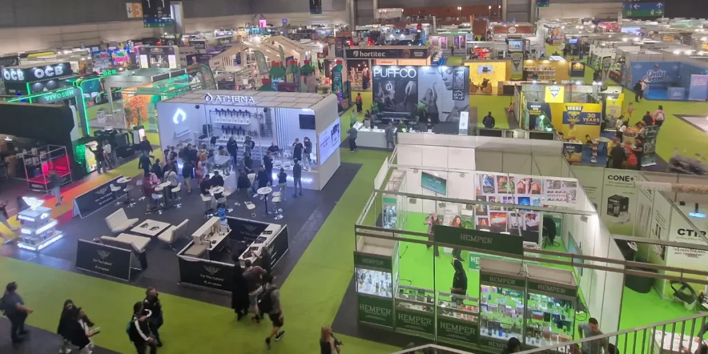 Large cannabis expo hall with multiple booths and attendees.