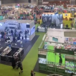 Large cannabis expo hall with multiple booths and attendees.