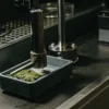 Laboratory device compressing and testing a cannabis sample in a modern analytical environment.