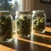 Cannabis curing jars sunlight storage with multiple glass containers filled with dried buds on a wooden table.