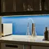 Cannabis extraction lab setup with glassware, equipment and plant samples on workbench.