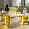 Cannabis oil laboratory vials sunlight with multiple glass dropper bottles and test tubes on a wooden surface.