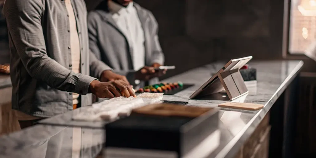 Cannabis dispensary staff organizing premium Delta 9 THC gummies at a modern retail counter.