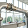 Water condensation on metal pipe inside laboratory environment.