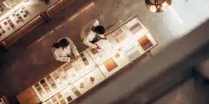 Scientists analyzing soil samples and materials on a laboratory table from top view.