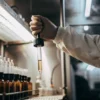 Laboratory technician using pipette to test cannabis extract in sterile research facility.