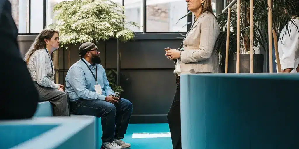 Professionals networking and discussing business at a cannabis industry conference.
