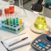 Cannabis laboratory workbench with chemical samples, test tubes, and marijuana analysis equipment.