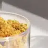 Cannabis buds stored in a transparent container during controlled post-harvest storage and preservation.