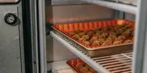 Cannabis buds arranged in a small-batch curing system designed for controlled moisture management and flower preservation.