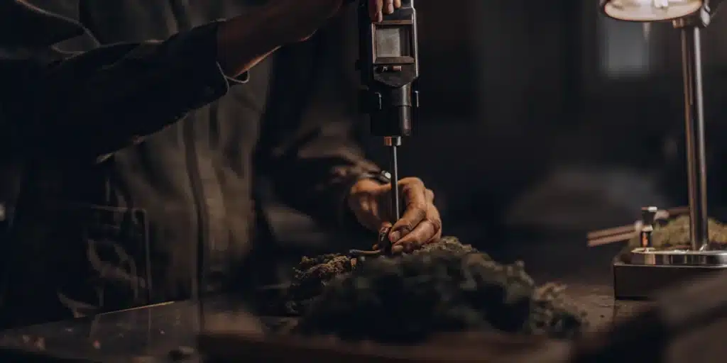Cannabis moisture content testing using a probe device to measure flower quality and consistency.