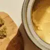 Cannabis flower and infused butter prepared for homemade cannabis butter production in a kitchen setting.