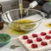 Preparing homemade THC gummies with cannabis-infused oil, droppers, and silicone candy molds.
